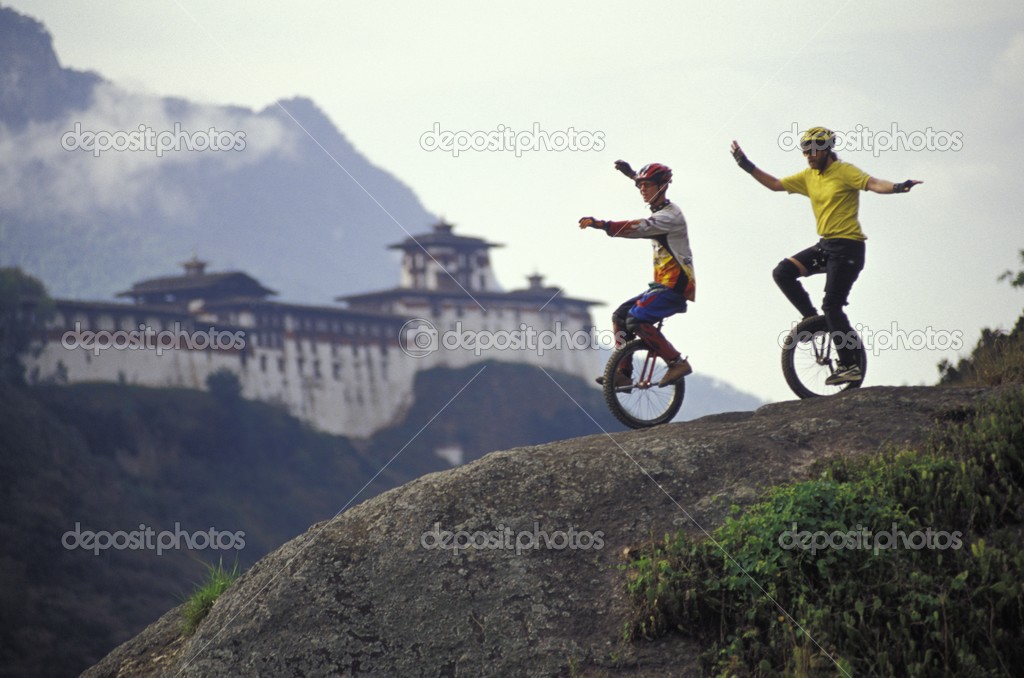Unicyclists Riding Down Hill