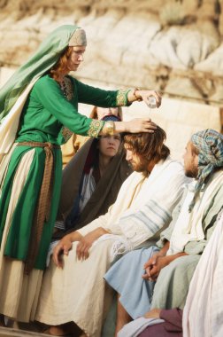 Woman Pours Oil On Jesus' Head clipart