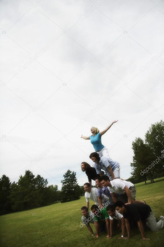 A Group Of Young People Making A Pyramid