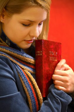 Teen Holds Bible And Prays clipart
