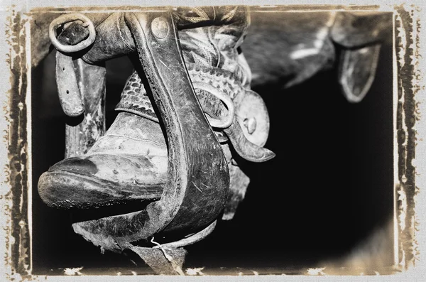 A Black and White Photo of A Cowboy Boot And Stirrup — стоковое фото