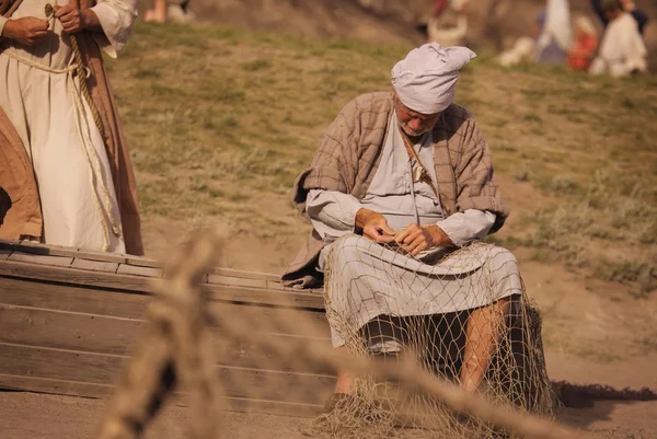 A Fisherman Mending His Nets — Stock Image A Fisherman Mending His Nets Royalty Free Stock Images