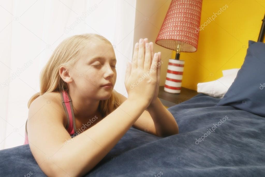 Child Prays At Her Bedside