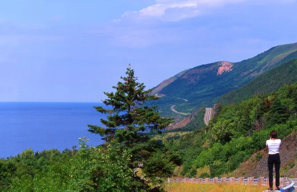 Turista tomando una foto de una escena de montaña y el océano — Foto de Stock