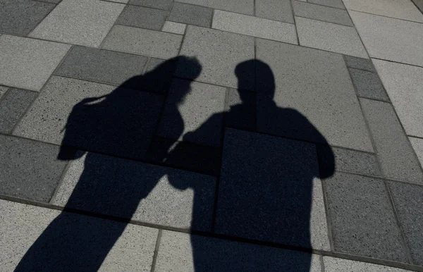Shadow Of Two People Standing Royalty Free Stock Photos