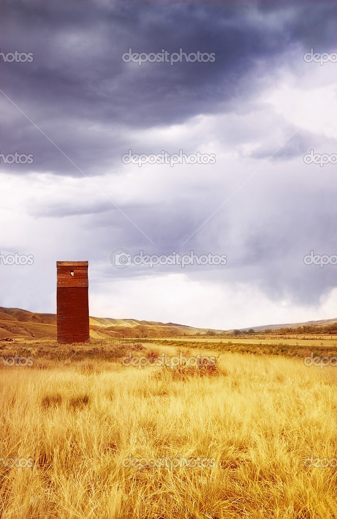 A Grain Elevator In A Field