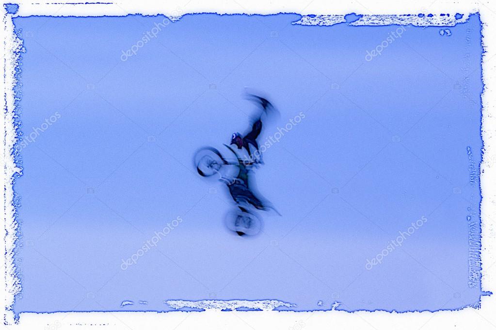 Blurred Silhouette Of Biker Against Sky