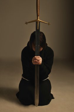 Person Kneeling With A Sword clipart