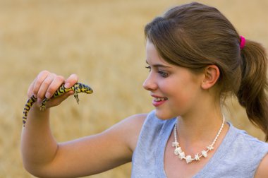 Young Lady Holding A Tiger Salamander clipart
