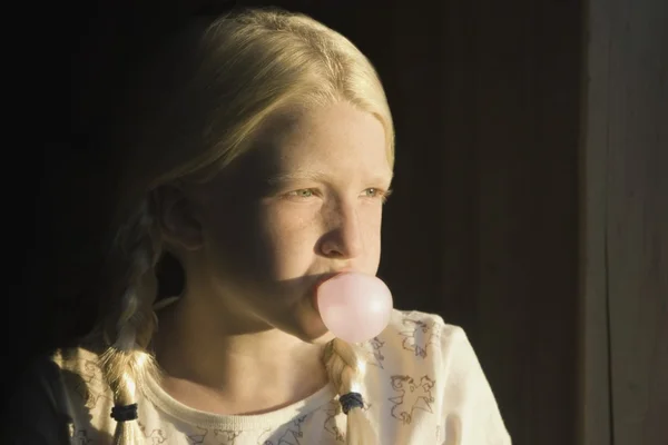 Mädchen bläst eine Blase mit Kaugummi — Stockfoto