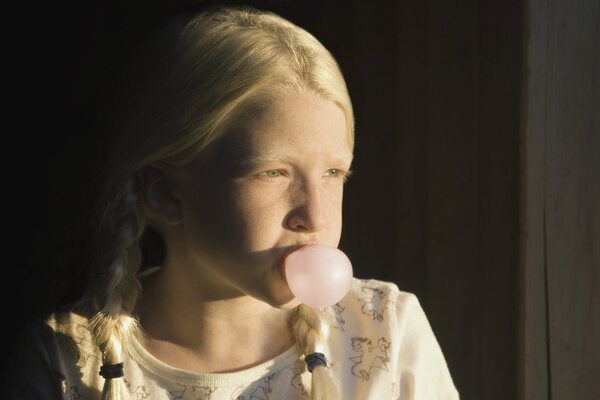 Girl Blowing A Bubble With Gum