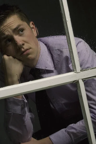 Unhappy Man Looking Out A Window — Stock Photo, Image