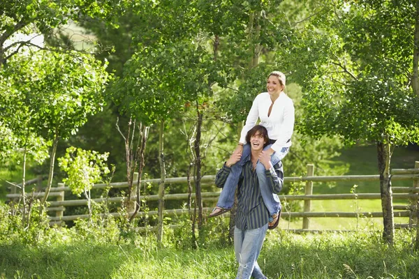 Man Carrying A Woman On Shoulders — Stock Photo, Image