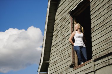 Young Woman In Barn Loft clipart