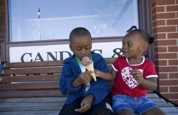 Garçon et fille partageant cône de crème glacée — Photo