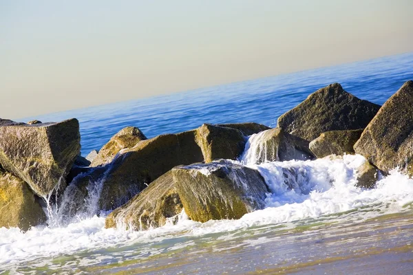 Ozean ergießt sich über Felsen — Stockfoto