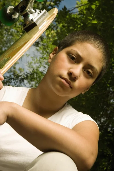 Jonge vrouw met skateboard — Stockfoto