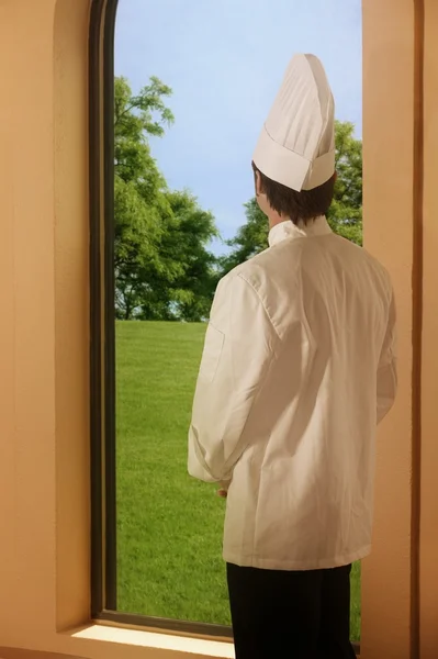 A Chef Looking Outside A Window — Stock Photo, Image