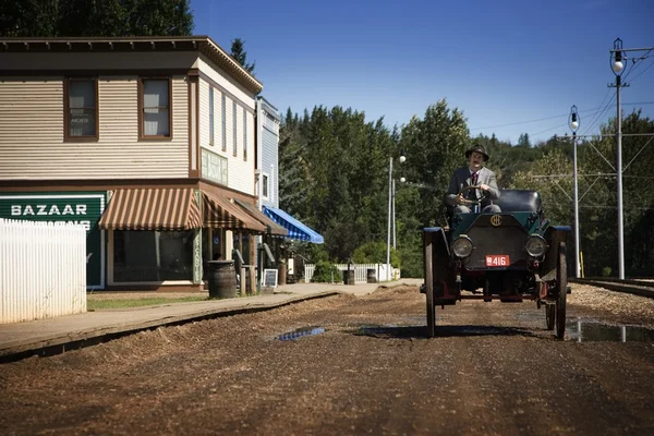 Hombre en traje de época conduciendo un coche vintage — Foto de Stock