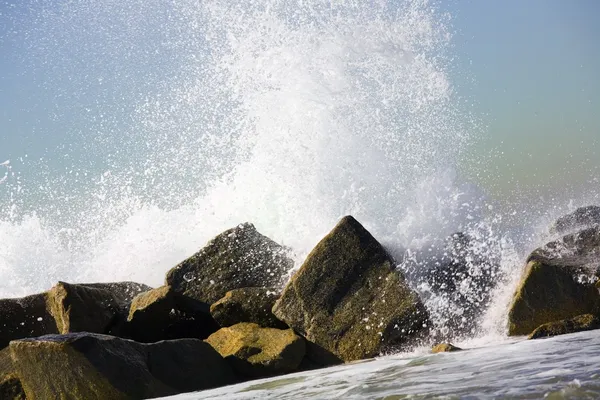 Vatten brakande över stenar — Stockfoto
