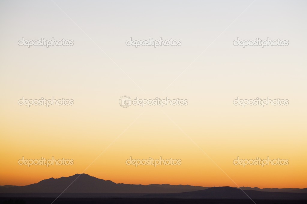 Sunset Sky Over Silhouetted Mountains