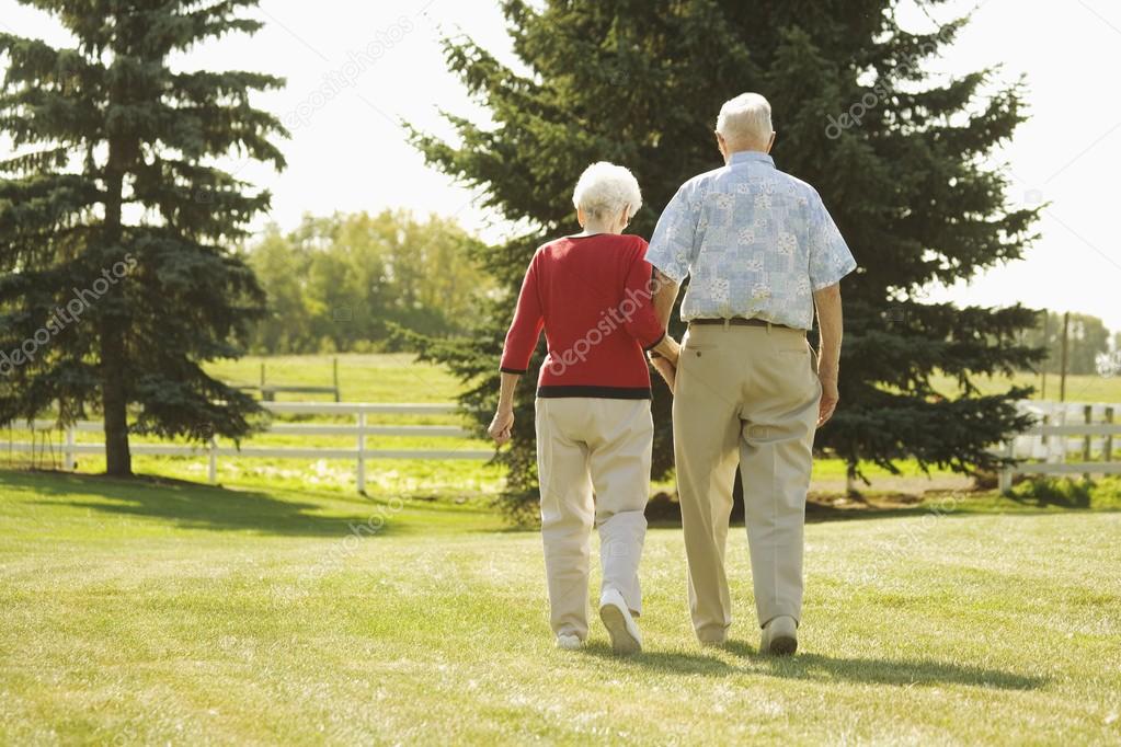 Senior Couple Walking Hand In Hand