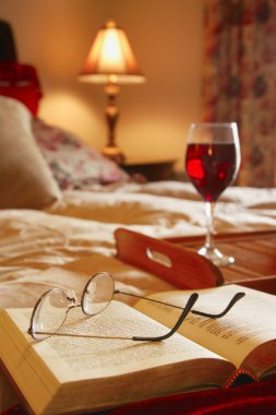 Glasses Resting On An Open Book clipart
