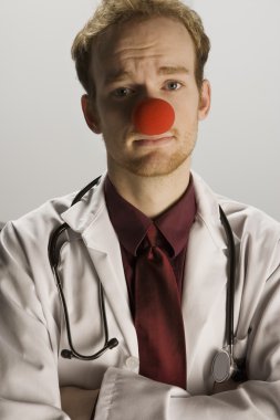 bir palyaço burnu giyen doktor