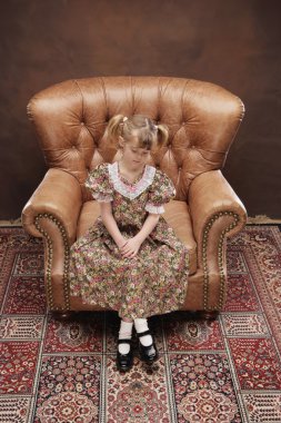 Girl Sitting In Armchair clipart