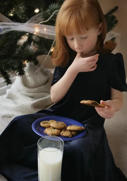 Ragazza mangiare latte e biscotti — Foto Stock