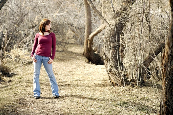 Junge Frau posiert in einem Waldstück — Stockfoto