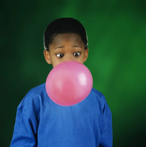 Menino soprando enorme bolha com chiclete — Fotografia de Stock