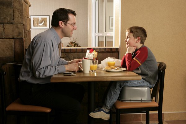 Father And Son Eating Together