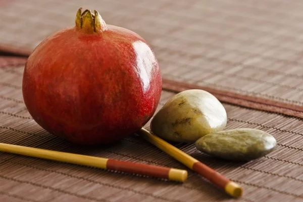 Pomegranate With Chopsticks And Pebbles — Stock Photo, Image
