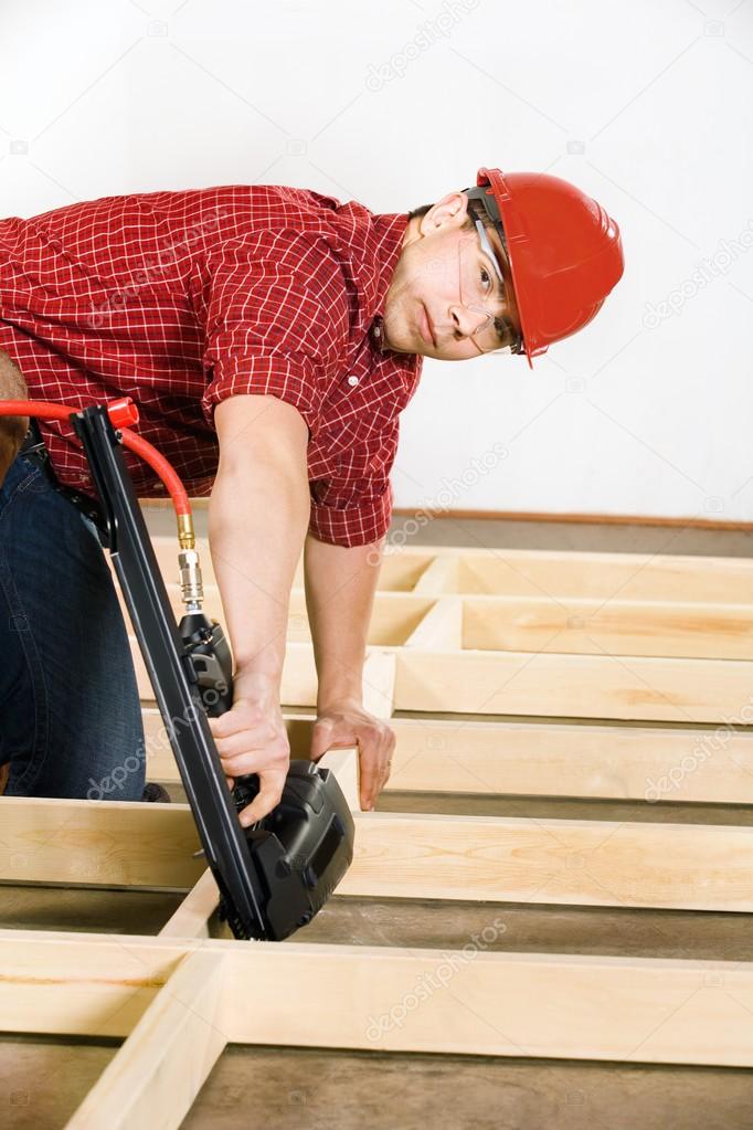 Carpenter Working With Nail Gun