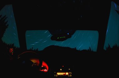 Night Star Trails Through Window Of A Vehicle clipart