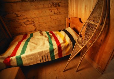 Historical Bedroom With Hbc Blanket And Snowshoes clipart