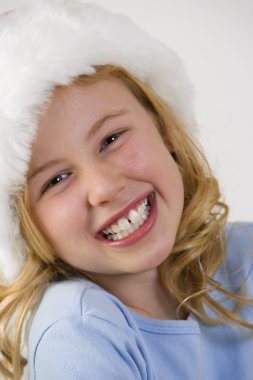 Young Girl Wearing A Fuzzy Hat clipart