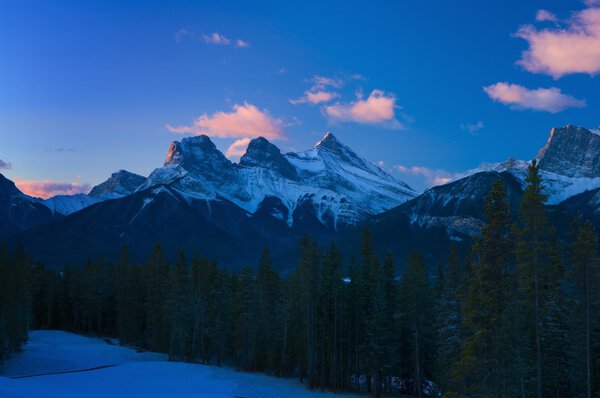 Three Sisters Mountain Range At Sunrise, Canmore, Alberta, Canada