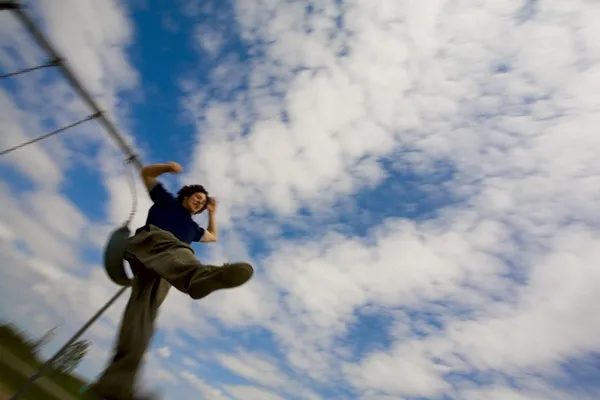 Person Jumping Off A Swing — Stock Photo, Image