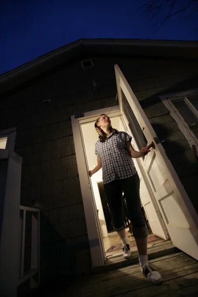 Woman Stepping Out Of A House — Stock Photo, Image