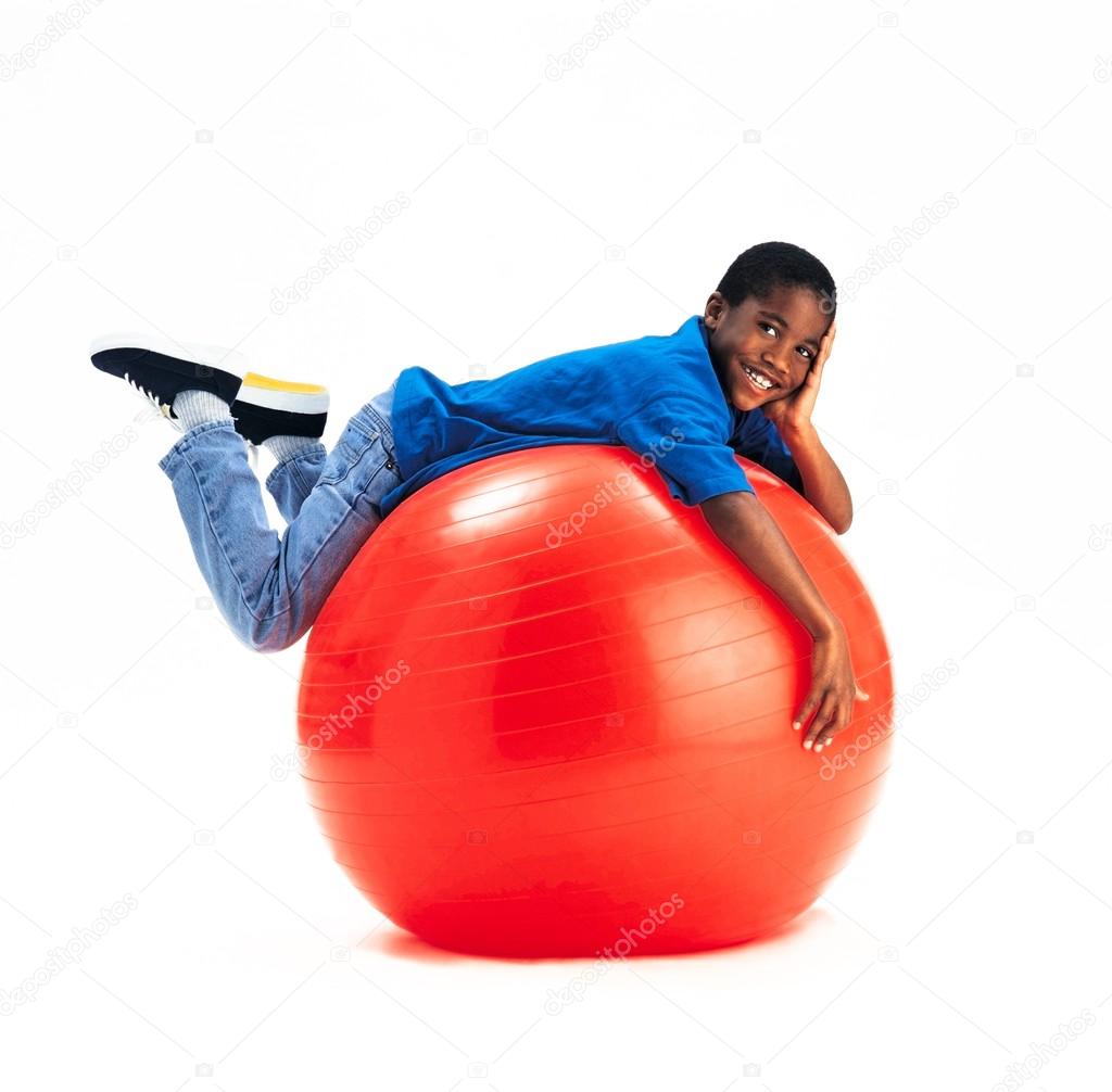 Young Boy Laying On Large Red Ball