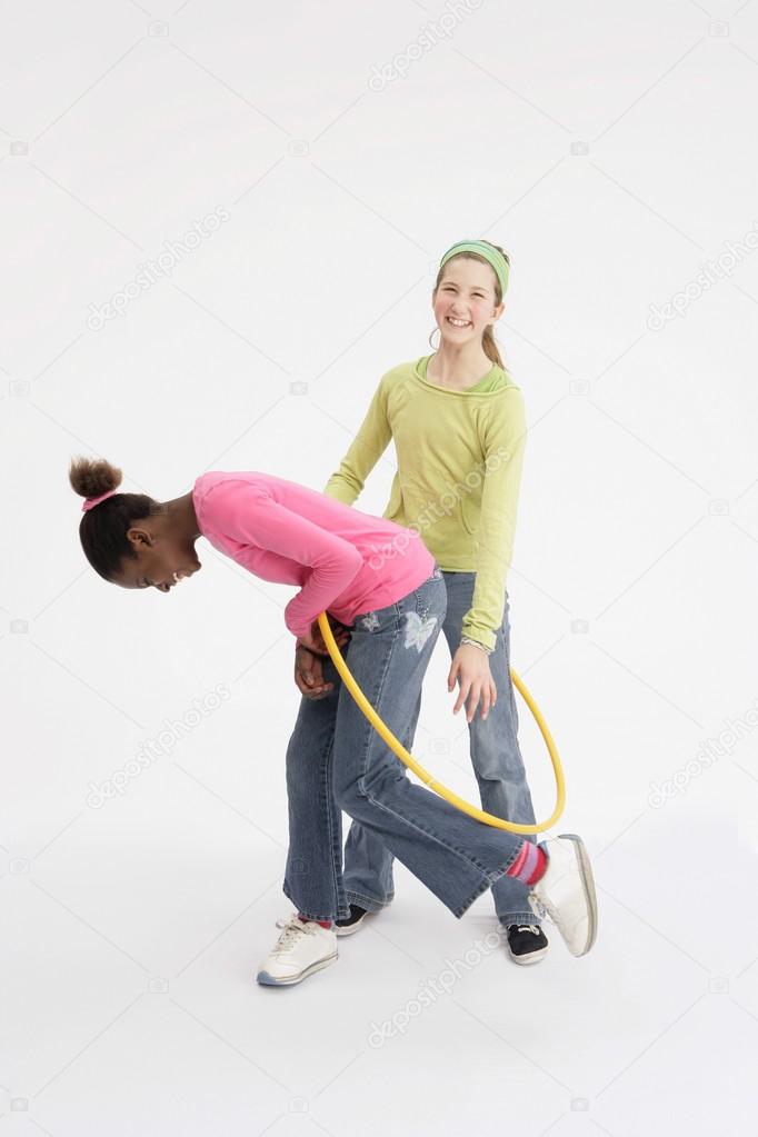 Two Girls Playing With Hula Hoop