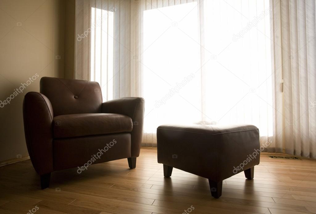 Living Room With Armchair And Ottoman