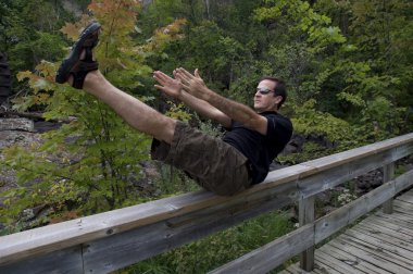 Man Stretching On Bridge, Bracebridge, Ontario, Canada clipart