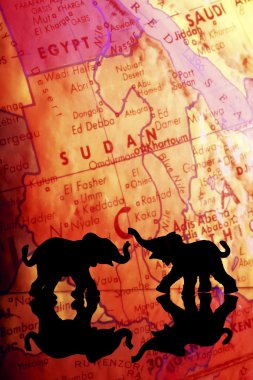Elephant Silhouettes In Front Of A Map clipart