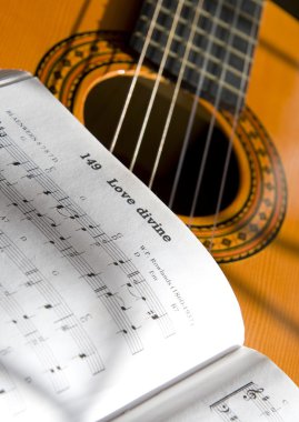 Guitar And Book Of Music clipart