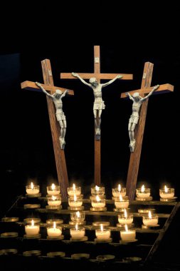 Three crosses depicting crucifix with candles clipart