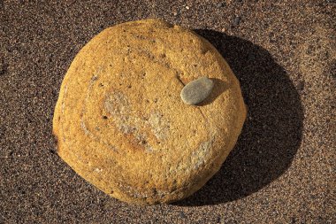 küçük ve büyük bir taş üzerinde kum