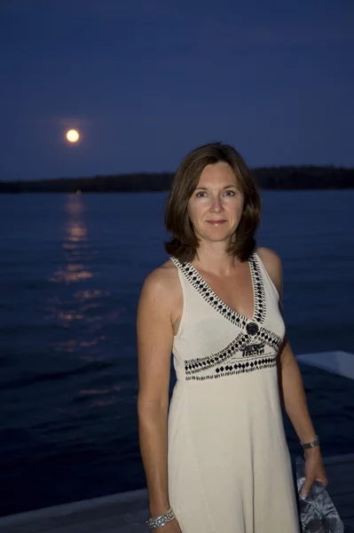 Woman on dock at night — Stock Photo, Image